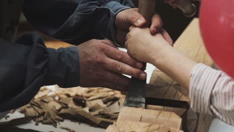 A-woman-trying-to-learn-something-about-wood-engraving-with-more-help