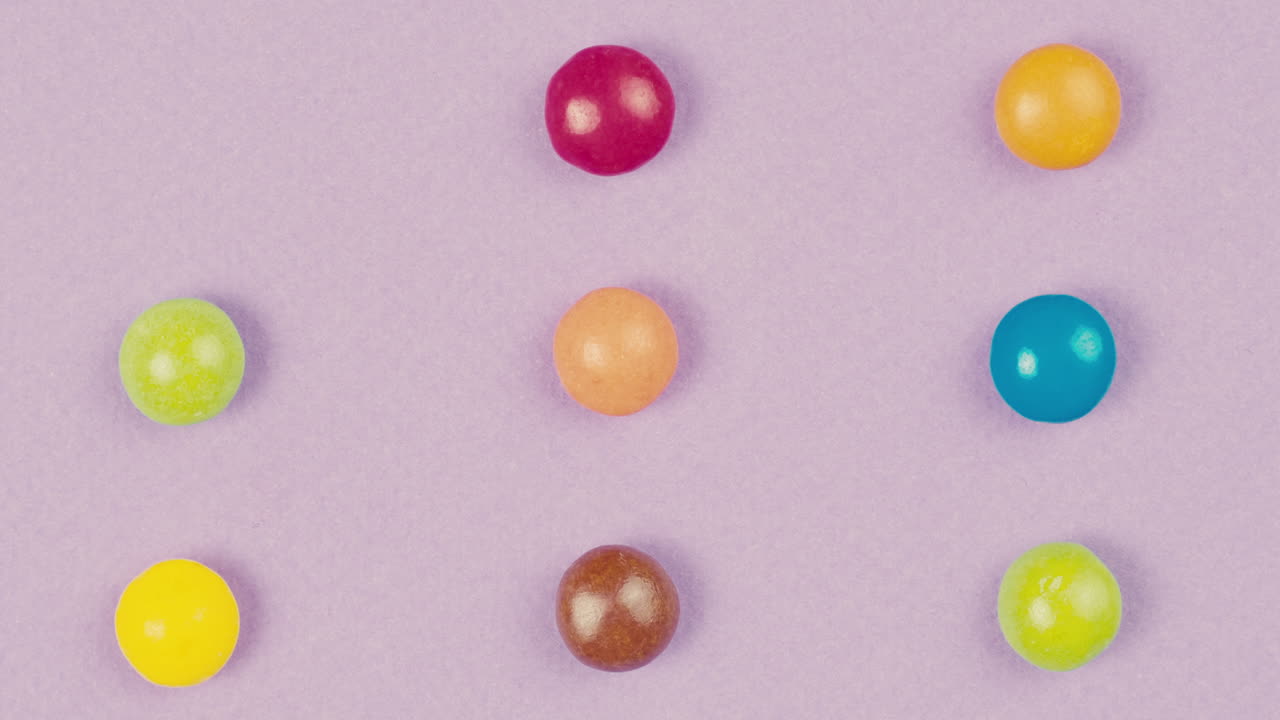 Colorful Round Candies on Purple Background