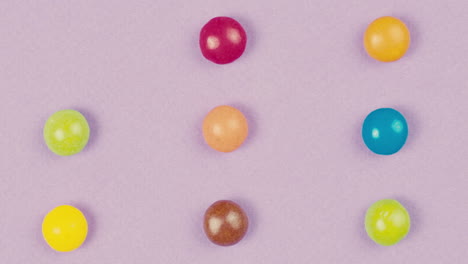 colorful round candies on purple background
