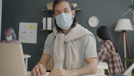 people wearing masks in an office setting