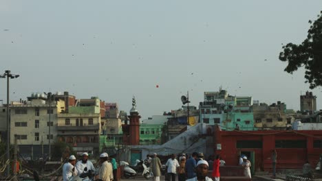 locked-on shot of people on street in a city, delhi, india