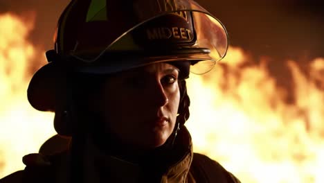 a dedicated firefighter stands resolutely amidst towering flames, showcasing their bravery and commitment to safety. this intense moment highlights the challenges faced in emergency response.