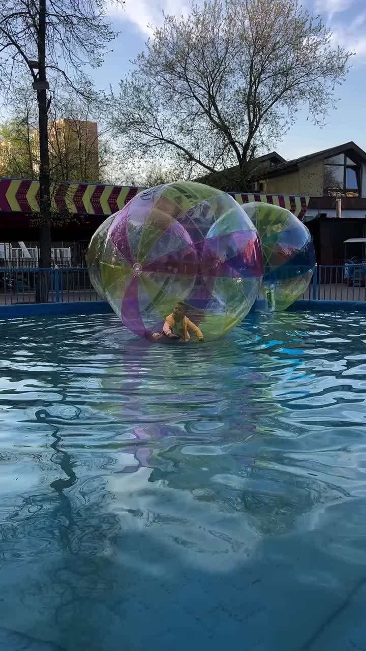 Child playing in a water walking ball