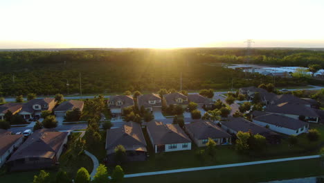 Quick-horizontal-dolly-over-homes-and-a-farm-during-the-sunset