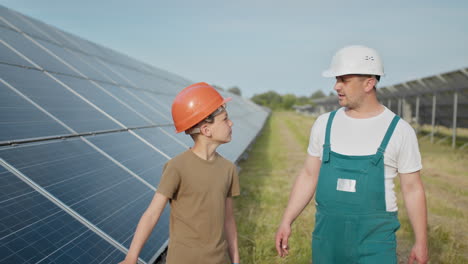 father and son at solar panel farm