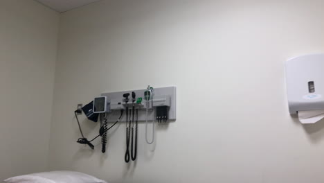 panning shot across an empty hospital room bed.