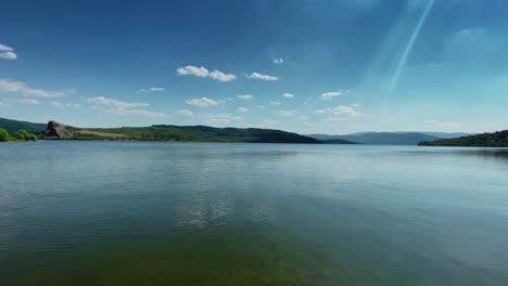 beautiful lake in sunny day with clear sky ang green water horizon