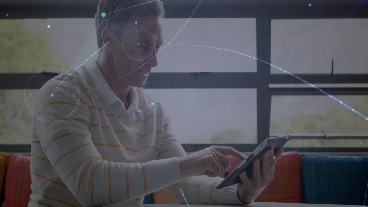 Using tablet with digital network animation, man working in modern office