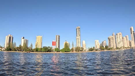 city skyline reflecting on water at sunset