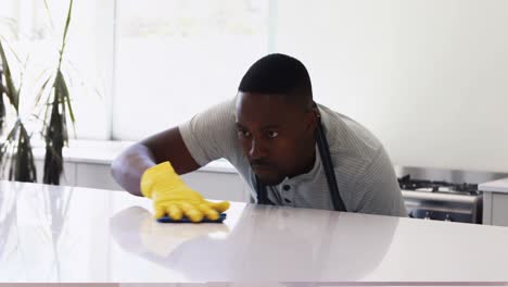 man cleaning the kitchen worktop