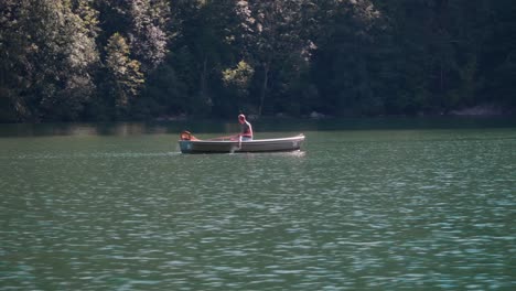 Man-rowing-boat-across-the-Koenigssee-on-a-beautiful-sunny-summer-day