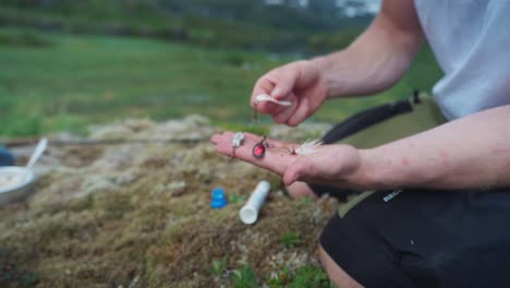 Hombre-Con-Variedad-De-Cebos-De-Pesca-En-Mano-Abierta