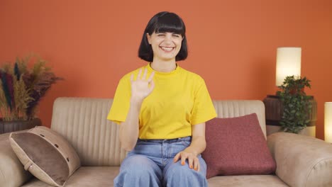 happy woman waving at camera.