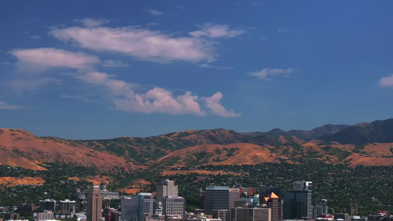 Downtown Salt Lake City SLC Utah USA Wasatch Mountain Range aerial drone summer blue sky morning afternoon LDS temple The Great Salt Basin Lake County region office buildings opening scene pan down up