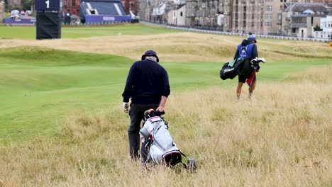 two golfers walking across the field