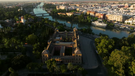 palacio de san telmo - baroque palace and government seat at sunrise on the banks of canal de alfonso xiii in seville, spain