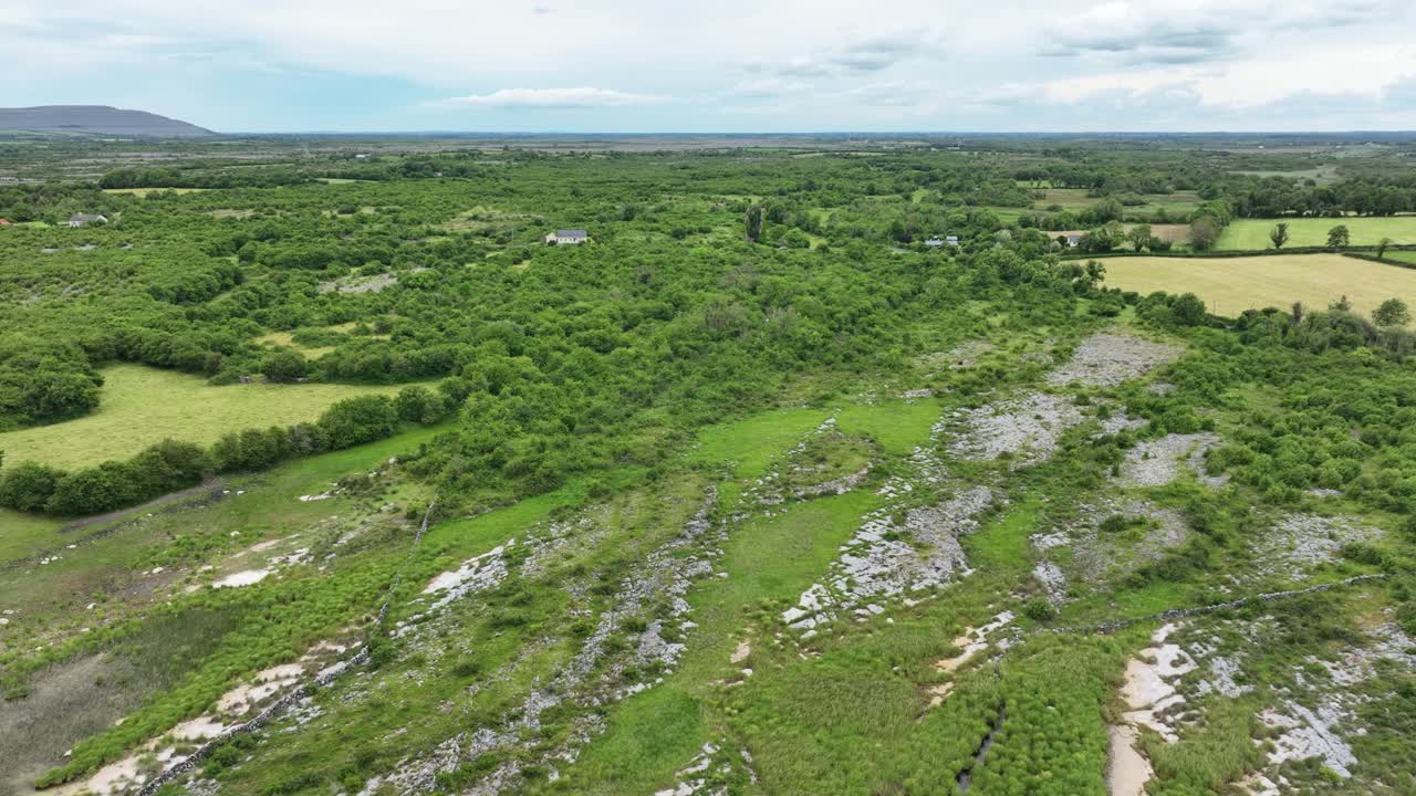 Ireland Epic locations and Landscapes drone flying over water and lush green landscape to ruins of ancient castle The Burren Co. Clare in summer