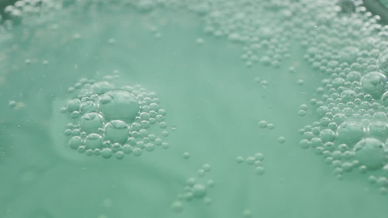 Close-up of bubbles in a green liquid