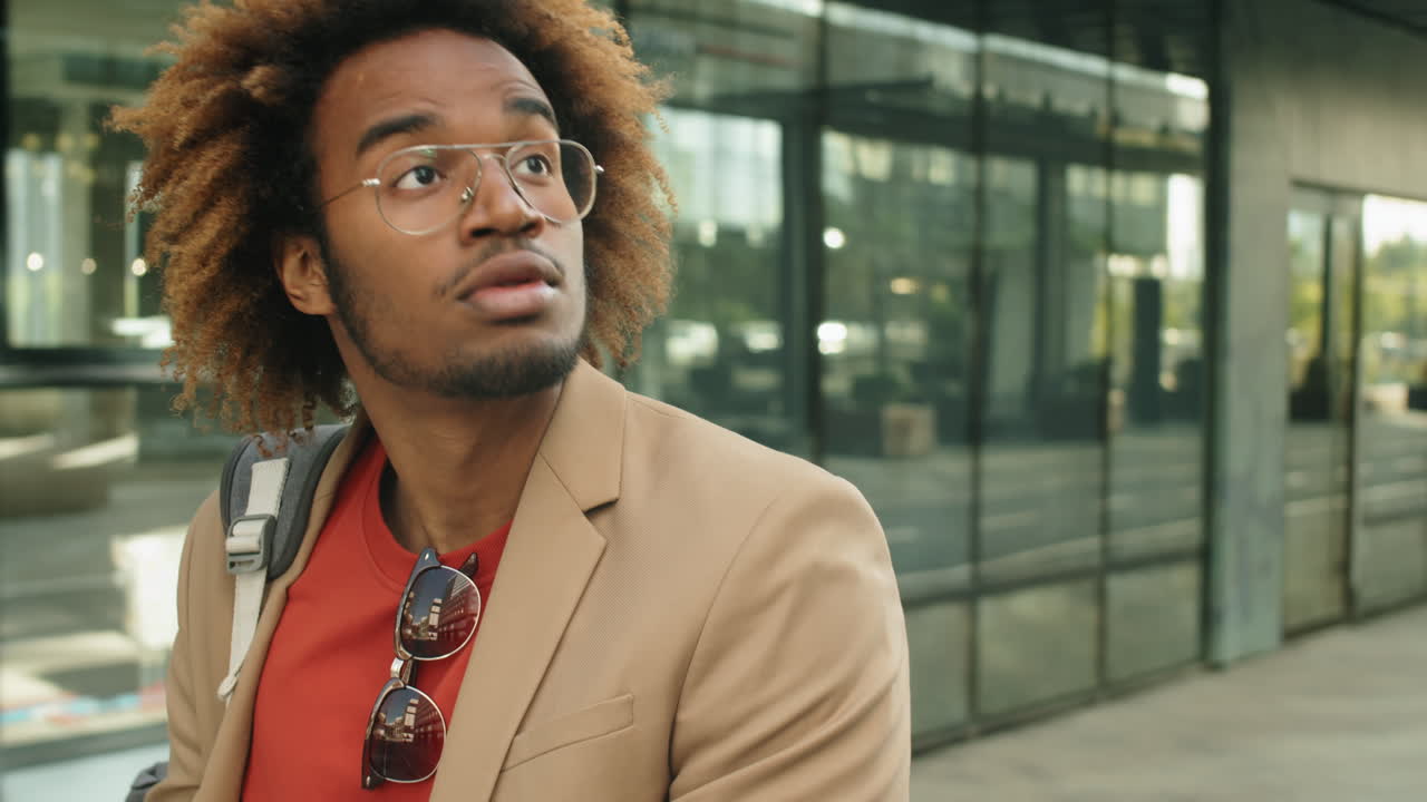 Young Black Businessman Riding E-Scooter in City