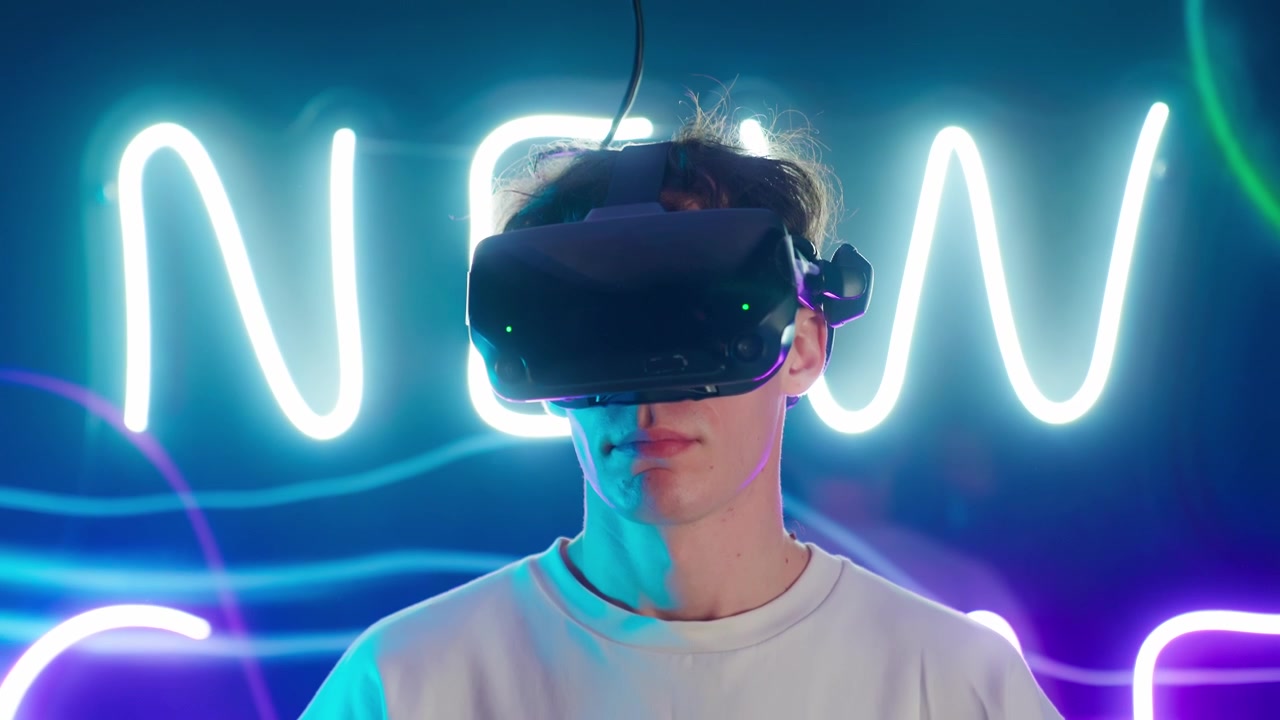 Young Man Immersed in Virtual Reality with Neon Lights