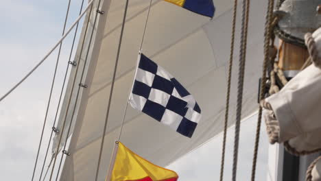 Nautical-flags-blowing-in-the-wind-on-a-sailboat,-slow-motion