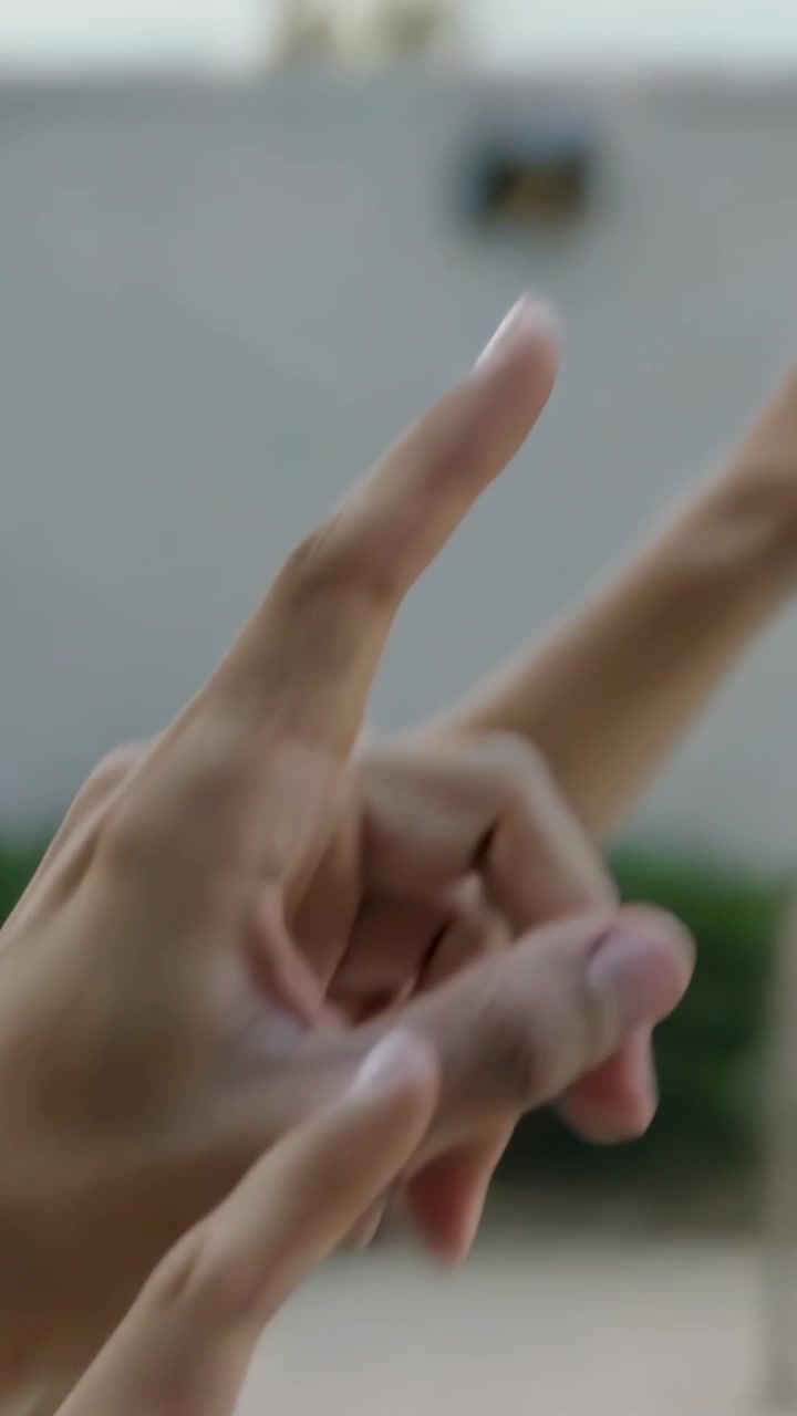 Vertical video: Pointing shirtless child mimicking adult guiding fingers at pool edge, showing sky
