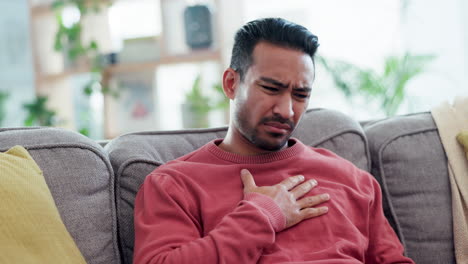 cough, sick and asian man on a sofa with chest