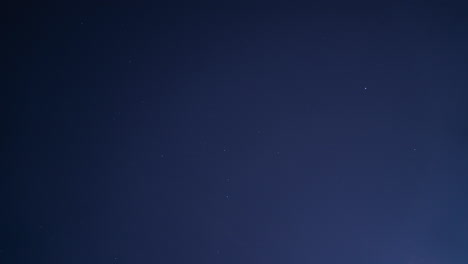 looking up on the heavenly sky filled with shining stars and clouds blown by the wind at night - timelapse