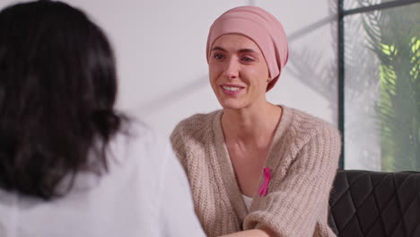 smiling woman patient wearing headscarf undergoing chemotherapy treatment for breast cancer getting good news at meeting with oncologist or doctor in hospital 1