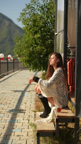 woman relaxing outdoors with a drink