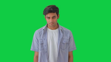 guilty indian boy trying to hide green screen