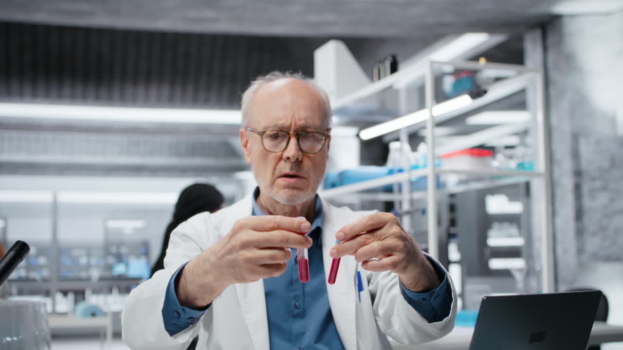 Senior scientist in lab analyzing batch of blood samples