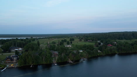 aerial footage of coastline of canadian cottage country during a calm evening on the water. calabogie ontario