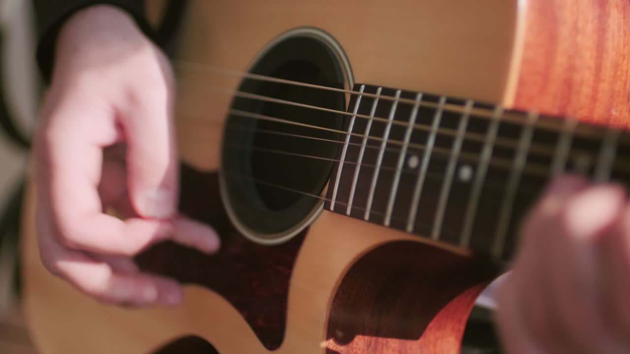 Hands of Musician Playing Acoustic Guitar