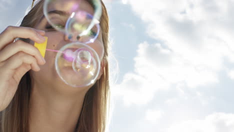 Beautiful-woman-blowing-bubbles-outdoors-sunshine-freedom-blue-sky-is-pretty