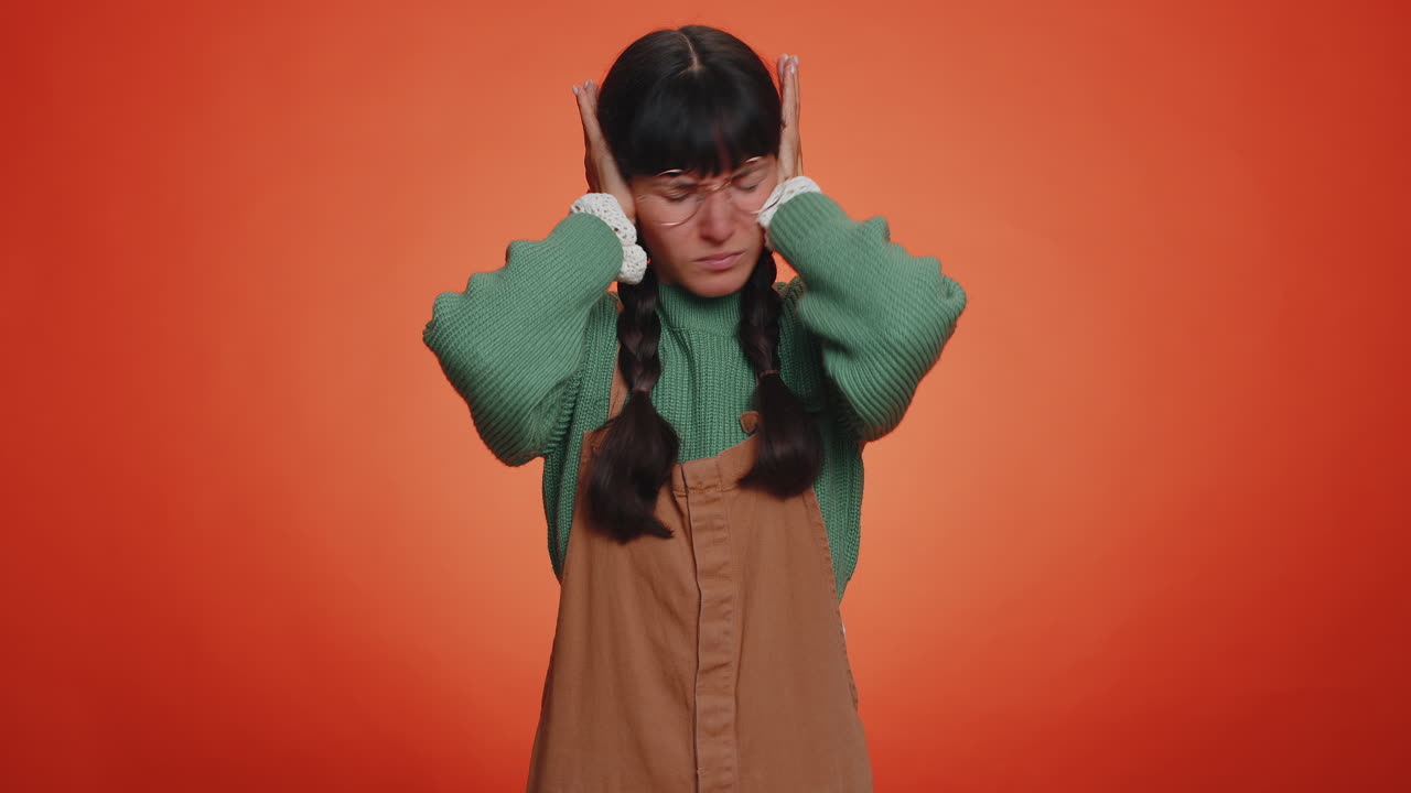 Annoyed irritated young woman covering ears, gesturing No avoiding advice ignoring noise loud voices