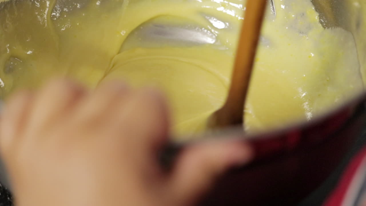 Children making a cake at home, close-up soft focus