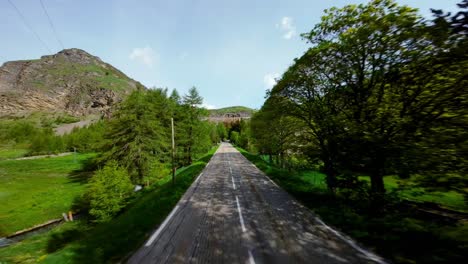 driving through an alpine valley on a clear day