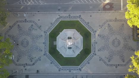 Aerial-top-down-view-of-the-most-famous-statue-near-Avenida-da-Liberdade-around-some-historical-and-ancient-cobblestones-in-the-center-of-Lisbon