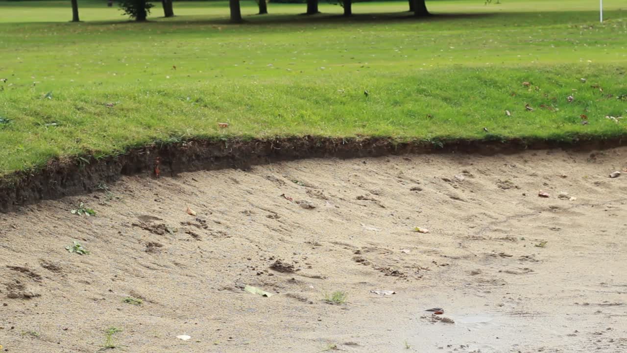 Slow close up pan of a sand bunker left to right.