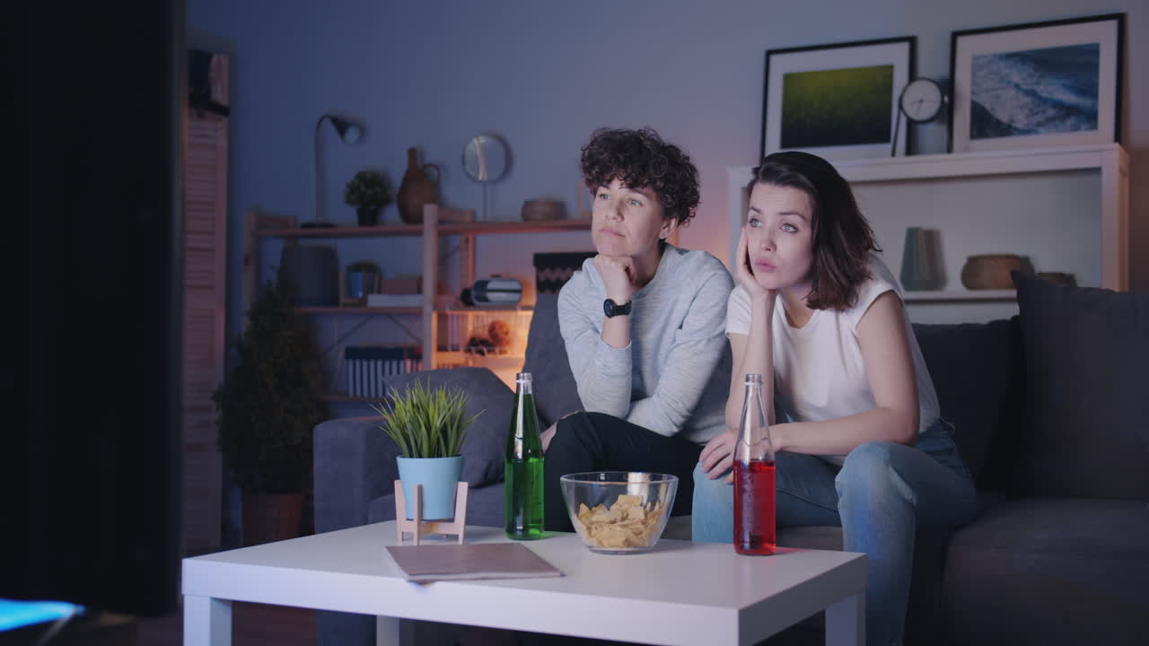 Two Friends Watching TV at Home