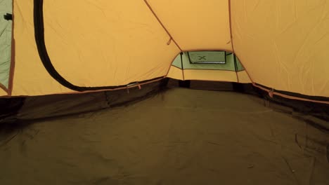 Inside-empty-large-tent,-camping-equipment-sleeping-outdoors-gear,-yellow-black