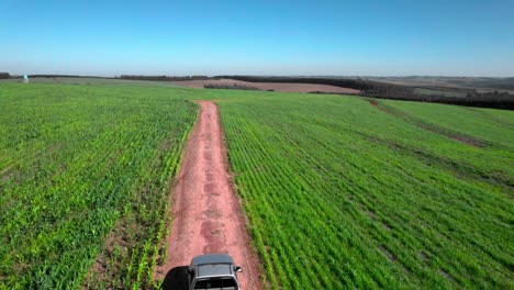 Farm-truck-along-a-countryside-dirt-road-on-a-huge-farm-in-Brazil---aerial