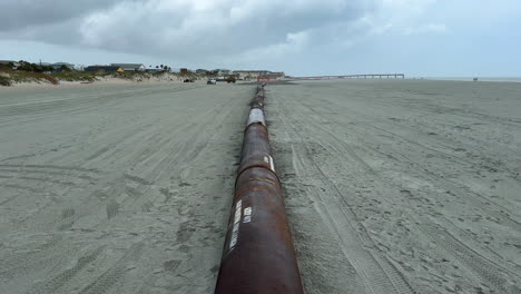 long pipe pumping sand from ocean for beach replenishment sandscaping