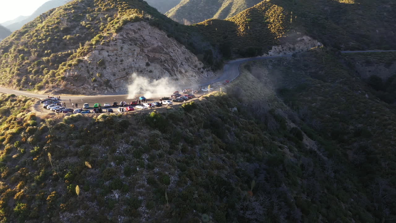Muscle and sports cars doing doughnuts and burnouts with a car club in the Angeles National Forest in Southern California