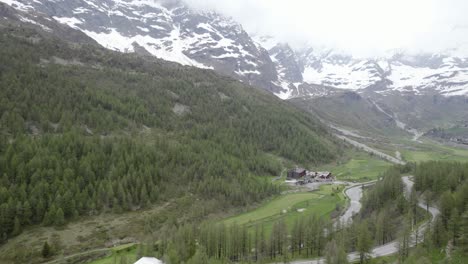 Establishing-shot-over-Lake-Blu,-tilting-up-towards-cloud-covered-Matterhorn