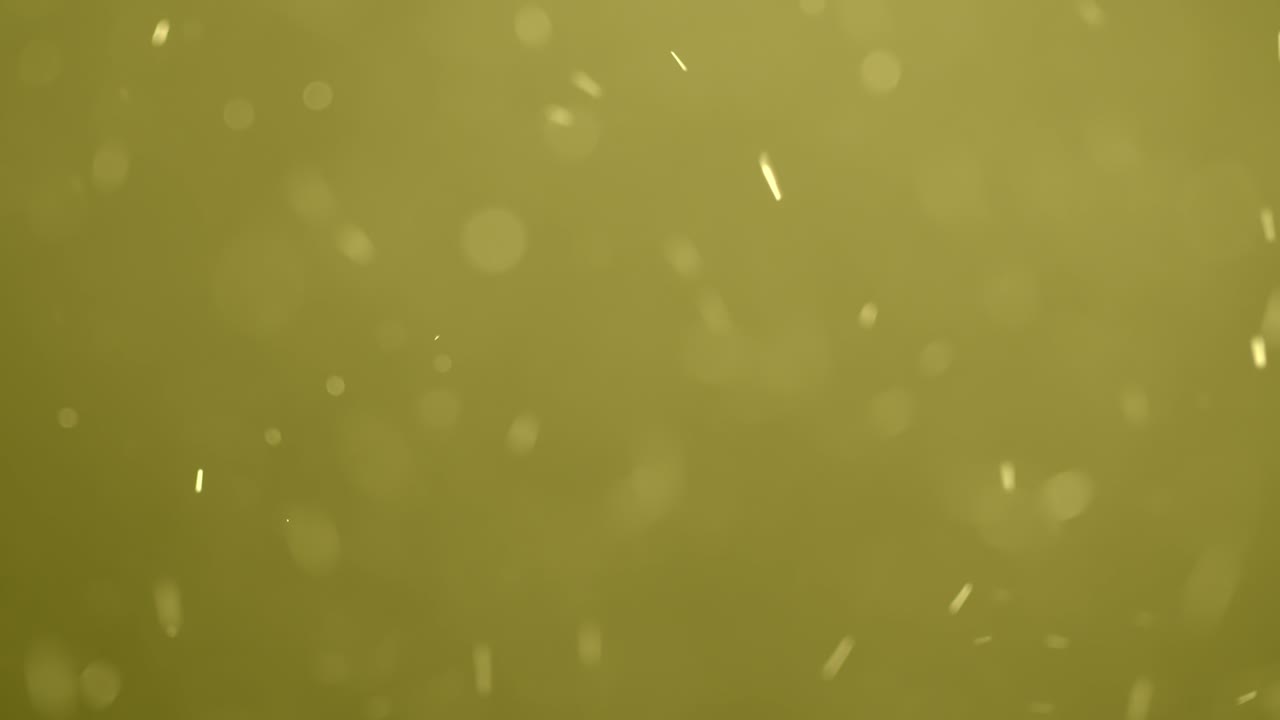 소용돌이치는 노란색 보케 입자
