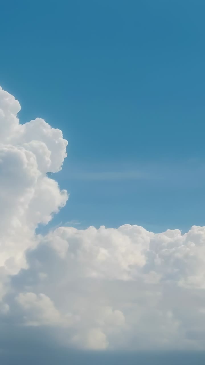 Vertical video: Camera tilting in sky showing cumulonimbus cloud forming base suggesting storm