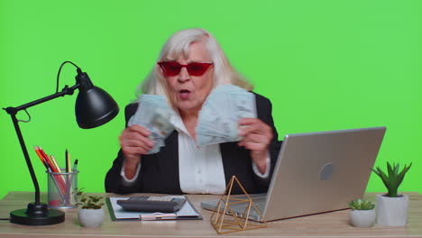 businesswoman office accountant celebrating business success dancing with stack of money dollar cash
