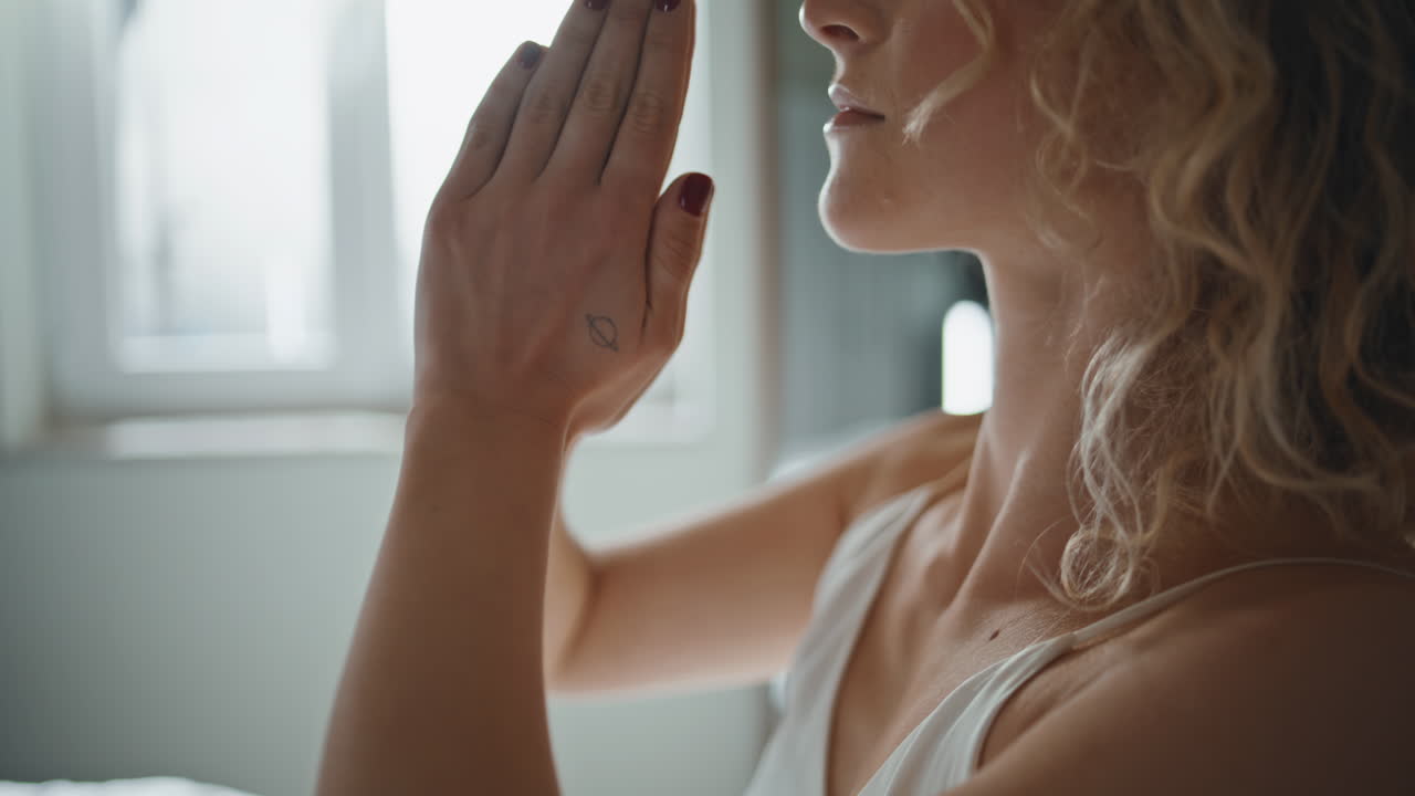 Yoga girl raising hands in asana closeup. calm lady meditating home